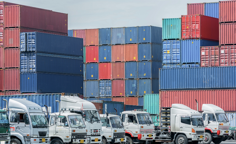 Shipping containers and trucks at logistics facility